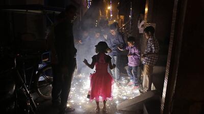 Children stand around watching firecrackers during Diwali celebrations in New Delhi on November 12, 2015. Altaf Qadri / AP