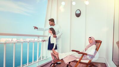 A family enjoys the balcony on the new QE2. PCFC Hotels