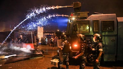 Lebanese security forces fire water cannon amdist clashes during a mass protest at Riad al-Solh Square in the centre of the capital Beirut. AFP