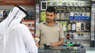 Many of us are overly attached to our gadgets. Photo Illustration by Philip Cheung / The National