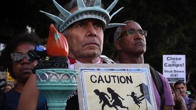 A man wears a Statue of Liberty crown during a protest in Los Angeles on July 12, 2019 against raids and arrests of asylum seekers by US immigration authorities. AFP