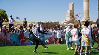 Players from the Let Gaza Live team and the Plastiquas team dance together before their match. Amy McConaghy / The National