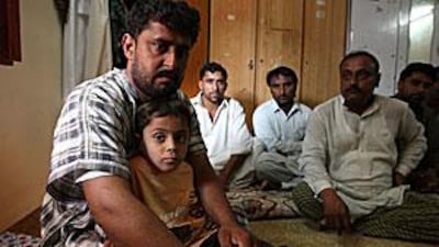 Mukhtiar Ahmed Khudabaksh with his son Mustaffa, 7, and other relatives at home in Dubai.
