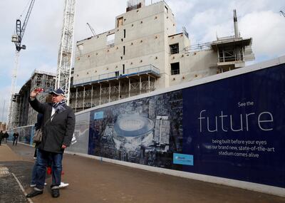 A man takes a selfie in front of construction work at White Hart Lane. Tottenham Hotspur are expected to return to the stadium in time for the 2018/19 season. Reuters