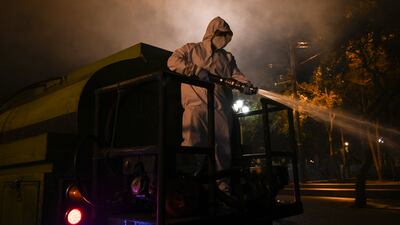 A municipal worker disinfects the streets in Guatemala City, Guatemala.