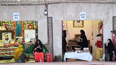 Emirati women sell clothes and perfume during the Dalma festival.
