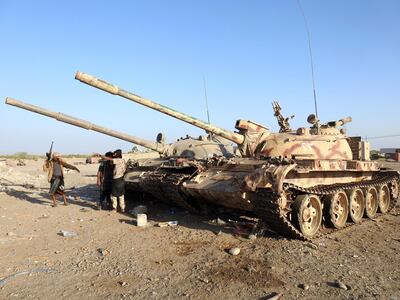 Yemeni pro-government soldiers stand nearby tanks on the outskirts of Hodeidah on January 4. EPA