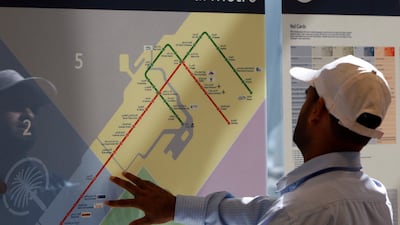 A passenger checks the Dubai Metro map at the Mall of The Emirates station, shortly after the network opened. Stephen Lock / The National