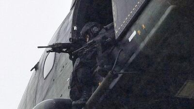 Armed security forces fly overhead in a military helicopter in Dammartin-en-Goele. Thibault Camus / AP Photo