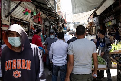 A man wearing a face mask shops at the market in Downtown Amman, Jordan. EPA photo