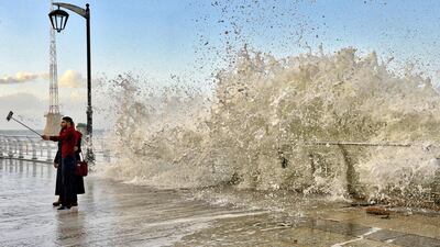 A couple take a selfie as a high wave hits the Corniche al-Manara in Beirut, Lebanon. EPA