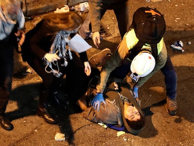 An anti-government protester receives helps after she was beaten by riot police, while she was was protesting outside a police headquarters demanding the release of those taken into custody the night before, outside a police headquarter, in Beirut, Lebanon. AP Photo