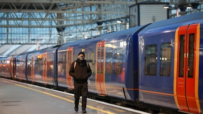 A man walks next to a train at Waterloo station during morning rush hour on Tuesday morning in London. Reuters