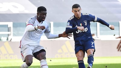 Juve's Cristiano Ronaldo shoots at goal under pressure from Musa Barrow of Bologna at the Allianz Stadium in Turin. EPA