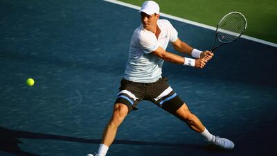Tomas Berdych of Czech Republic returns the ball to Sergiy Stakhovsky of Ukraine during their match in Dubai on Wednesday, February 26, 2014. Marwan Naamani / AFP