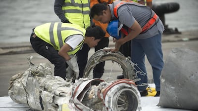 Investigators examine engine parts from the ill-fated Lion Air flight JT 610 at a port in Jakarta on November 7, 2018, after they were recovered from the bottom of the Java sea. AFP