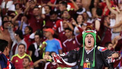 A Venezuela fan in full voice during the match. Marco Bello / Reuters