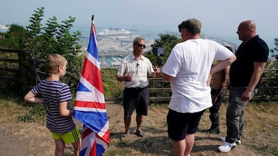 Brexit Party leader Nigel Farage (2nd left) talks to supporters in Dover. EPA