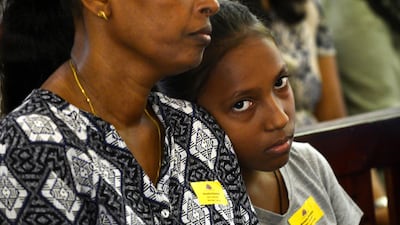 Sri Lankan Catholic devotees look on as they a mass at the St. Theresa's church as the Catholic churches hold services again after the Easter attacks in Colombo on May 12, 2019. Thousands of Catholics attended mass in Sri Lanka's capital Colombo on May 12 amid tight security to prevent a repeat of Easter bomb attacks that killed 258 people. / AFP / LAKRUWAN WANNIARACHCHI
