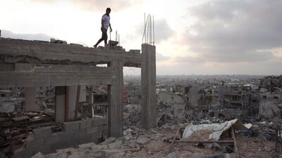 Room with a view: a Palestinian man on the top floor of his destroyed home over looking the destruction in the Shejaia neighbourhood of Gaza City.