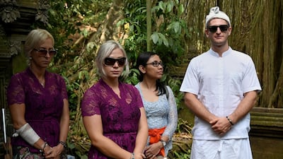 Czech nationals Sabina Dolezalova, second left, and her boyfriend Zdenek Slouka, right, at the Beji Temple, located inside a monkey sanctuary in Ubud. AFP