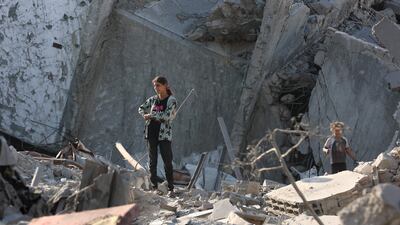 Palestinian girls react to the destruction after an overnight Israeli army air strike on Sheikh Radwan Health Centre in the north of Gaza city. AFP