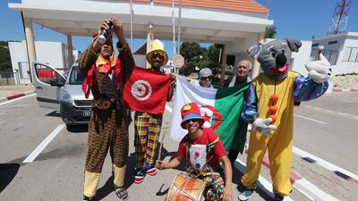 Algerian tourists taking a photo with Tunisian clowns after entering at the Malloula border post near Tabarka, on the first day of its reopening, in north-western Tunisia on 15 July 2022. Closed since the Covid-19 crisis in 2020, Algeria is proceeding on 15 July to reopen its land border with its neighbor Tunisia, one of the preferred destinations for Algerians. EPA / MOHAMED MESSARA