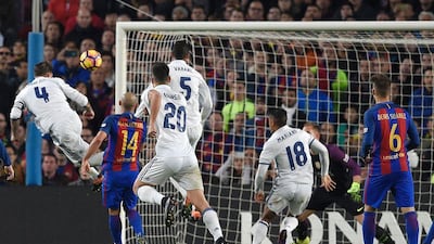 Real Madrid’s Sergio Ramos heads the ball to score the equaliser. Lluis Gene / AFP
