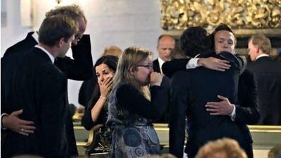 Mourners embrace during a memorial service yesterday at Oslo Cathedral in the aftermath of the attacks on Norway's government headquarters and a Labour Party youth retreat.