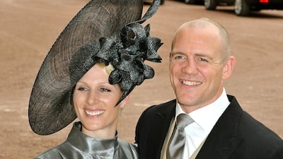 Zara Phillips, wearing a silver coat dress and dark grey head piece, and Mike Tindall leave the wedding reception for the Duke and Duchess of Cambridge at Buckingham Palace on April 29, 2011. Getty Images
