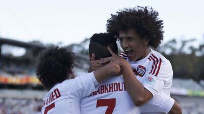 Ali Mabkhout, centre, is mobbed by teammates Mohamed Abdulrahman, left, and creator Omar Abdulrahman after the striker opened the scoring for the UAE just 14 seconds into their match against Bahrain. im Wimborne / Getty