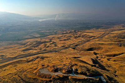 A picture taken on July 15, 2021, shows an abandoned Israeli army post in the Jordan Valley in the occupied West Bank near the border with Jordan (background). AFP