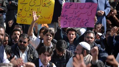 Employees of Pakistan International Airlines protest outside Benazir Bhutto International Airport in Islamabad on Friday. Aamir Qureshi / AFP