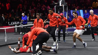 Team World run on to the court to congratulate Francis Tiafoe after he beat Team Europe's Stefanos Tsitsipas to win the Laver Cup at the O2 Arena in London, on September 25, 2022. EPA