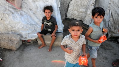 Palestinian children outside family tents in a placement camp in Gaza city. AFP