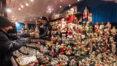 A man buys small Christmas-themed figurines in Frankfurt. AFP