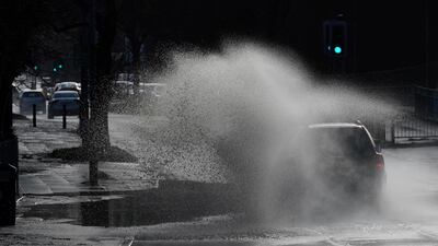 Cars drive through floodwater as hurricane-force winds and rain affected the country's transport network leading to disruptions and prompting warnings of power cuts and a risk to life, in Manchester, Britain. REUTERS