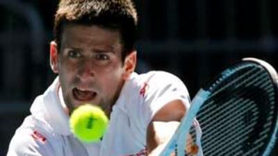 Novak Djokovic returns a shot against Lukasz Kubot during the Australian Open.