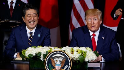 Japanese Prime Minister Shinzo Abe laughs as President Donald Trump speaks before signing an agreement on trade at the InterContinental Barclay New York hotel during the United Nations General Assembly in New York. AP Photo