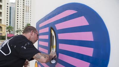 British street artist Ben Eine working on a mural at The Walk at JBR in Dubai. Antonie Robertson / The National