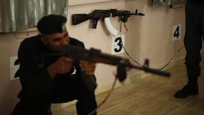 A member of Palestinian security forces loyal to Hamas aims a weapon during a training session which involves using laser to shoot at electronic targets, in Gaza City. Suhaib Salem / Reuters