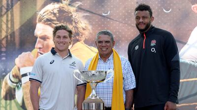 Michael Hooper (L), Mark Ella (C) and Courtney Lawes pose for pictures with the Ella Mobbs trophy. AFP
