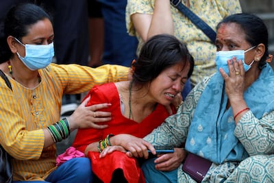 Relatives of the deceased who died in the Saurya Airlines plane crash mourn at a hospital in Kathmandu on July 24. AFP