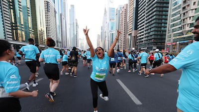 Runners take part in the Dubai Run 2025 on Sheikh Zayed Road, Dubai as part of the Dubai Fitness Challenge 30x30. Chris Whiteoak / The National.