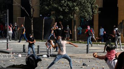 BEIRUT, LEBANON - AUGUST 08: Protesters throw stones during an anti-government demonstrations on August 8, 2020 in Beirut, Lebanon. The Lebanese capital is reeling from this week's massive explosion that killed at least 150 people, wounded thousands, and destroyed wide swaths of the city. Residents are demanding accountability for the blast, whose suspected cause was 2,700 tons of ammonium nitrate stored for years at the city's port. (Photo by Marwan Tahtah/Getty Images)