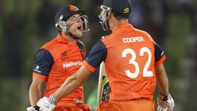 Netherlands' Been Cooper, right, and Wesley Barresi celebrate their team's victory against Ireland during the World Twenty20 tournament in Sylhet on Friday. STR / AFP / March 21, 2014