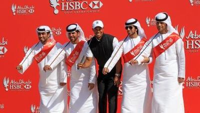 Tiger Woods moves to the beat with members of a traditional Emirati Ayala dance troupe at Abu Dhabi Golf Club.