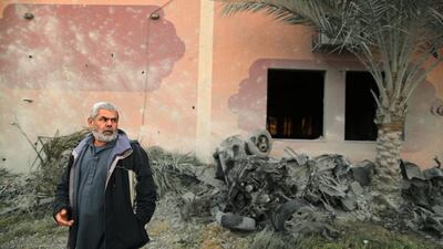 A Palestinian man looks on as he inspects the scene of Israeli air strikes. Reuters