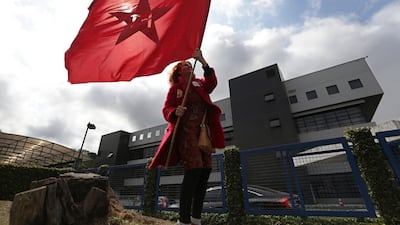 A supporter holds a Workers' Party flag in front of the prison where former president Luiz Inacio Lula da Silva is jailed for corruption. AP