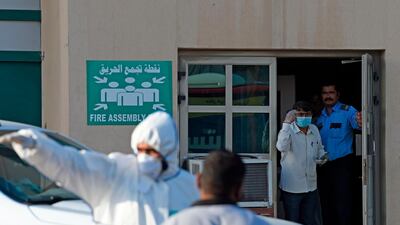 Bahraini policemen seal off a building housing foreign workers in the Salmabad industrial area as a precautionary measure after a resident tested positive for coronavirus, on the outskirts of the capital Manama. AFP